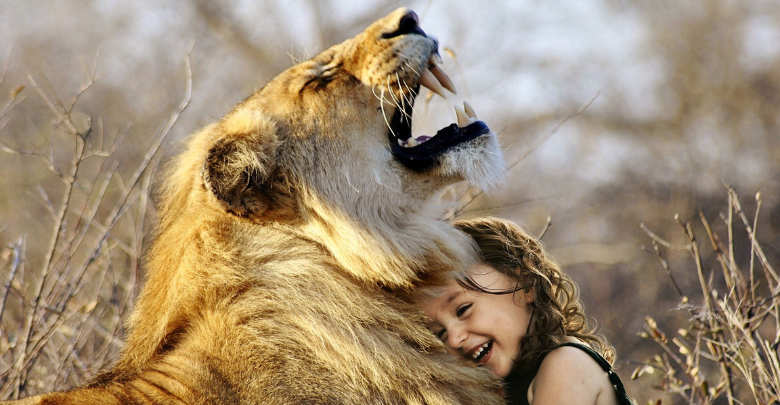bambina che abbraccia un leone